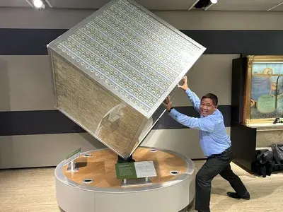 Carl in a money cube at a museum